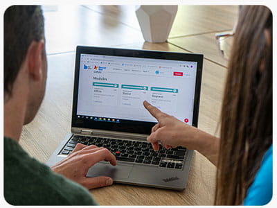 Educators working together on a laptop