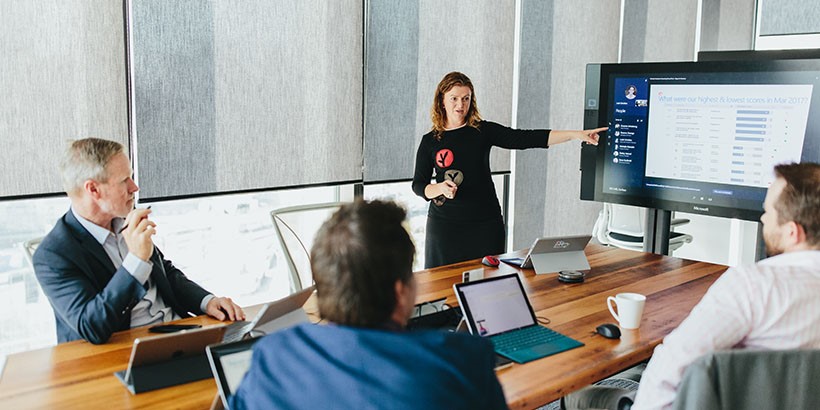 Educators taling together in a boardroom