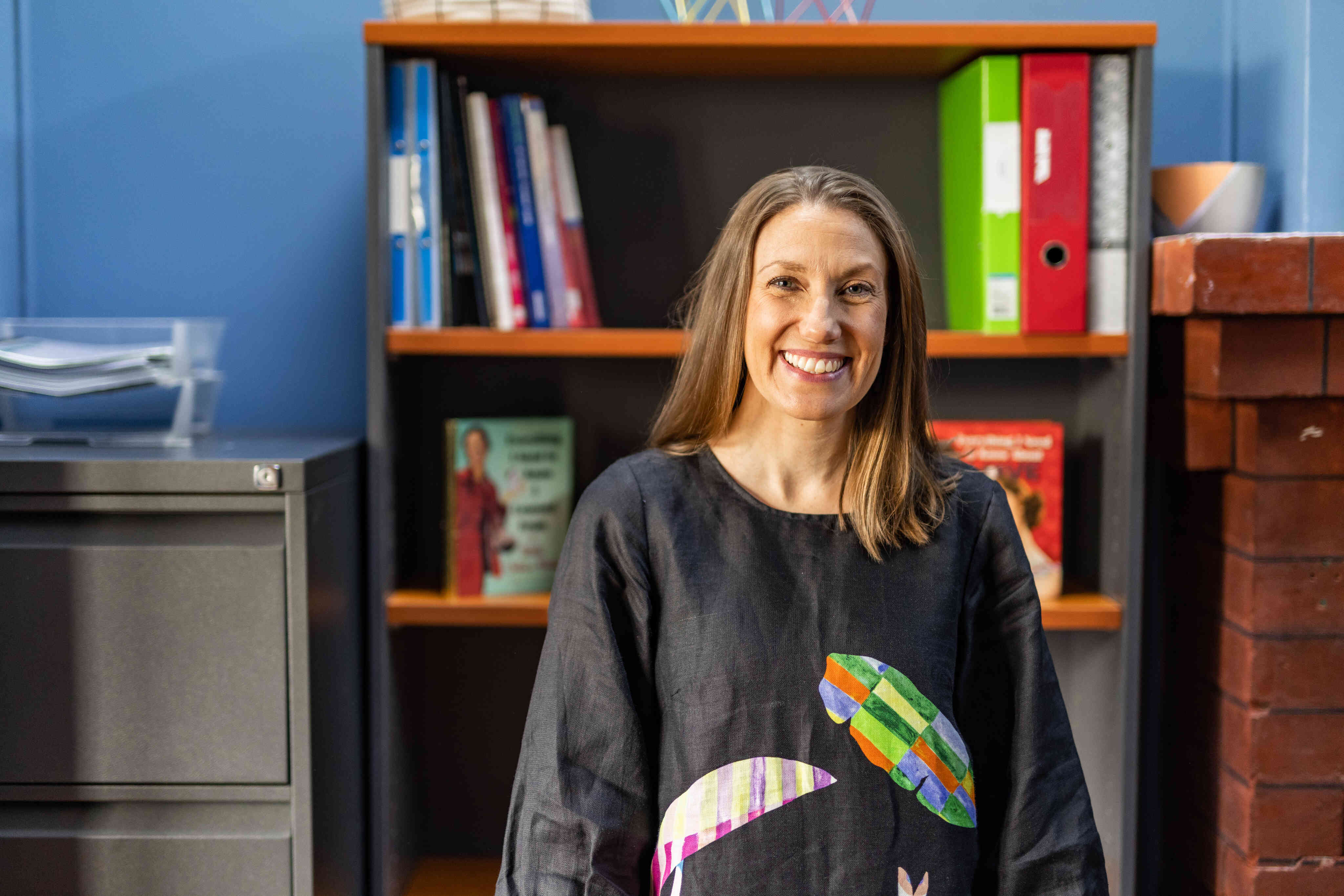 Educator smiles in an office