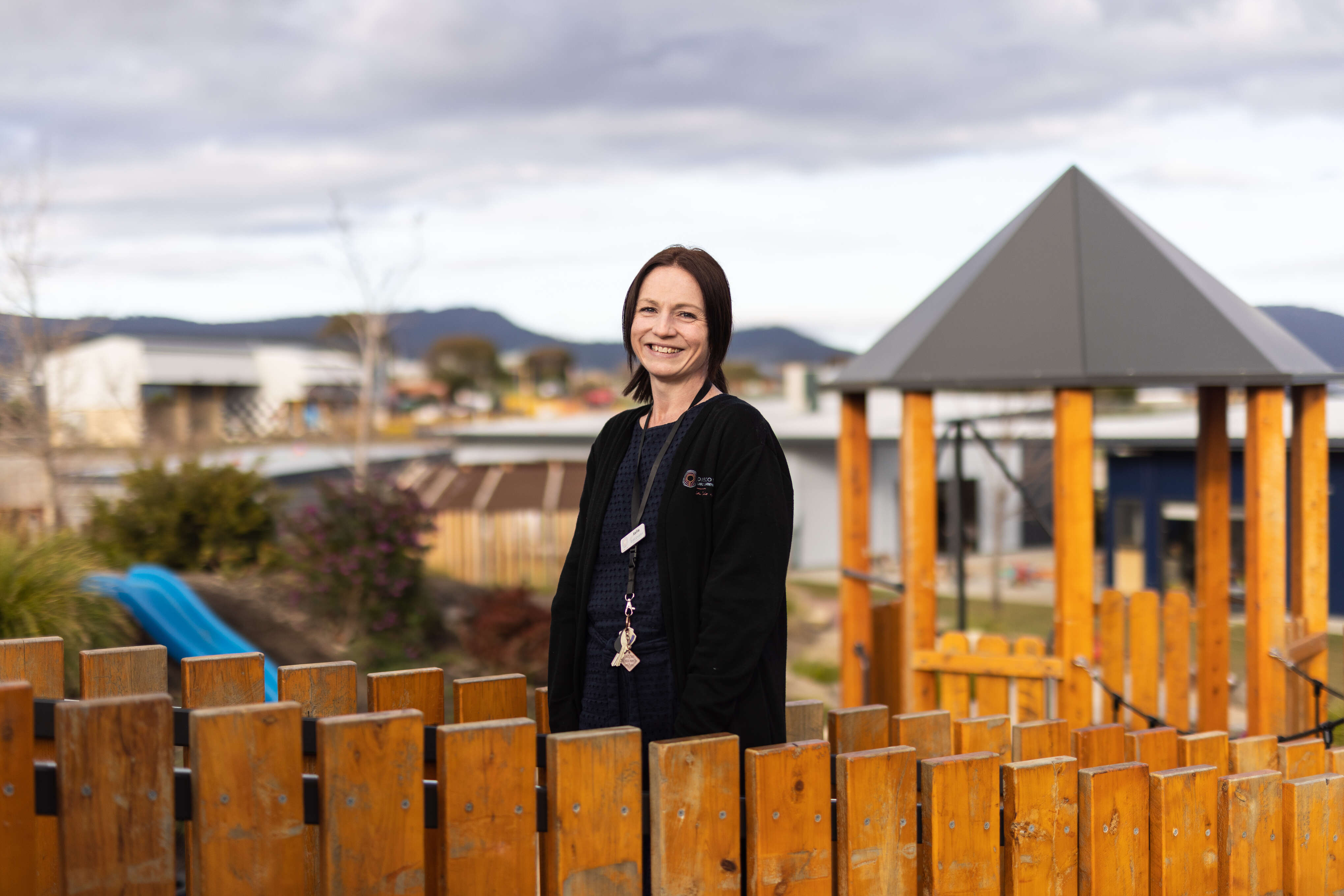 Educator smiles in a playground