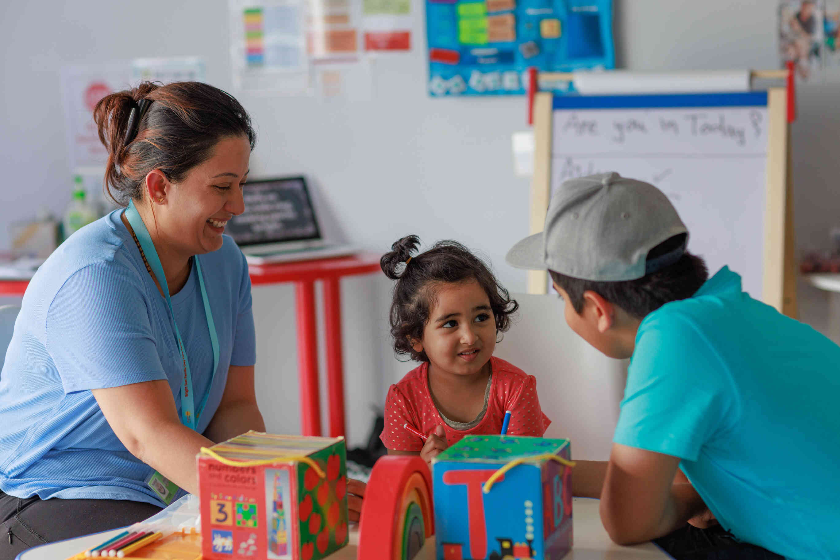 An educator plays with two children