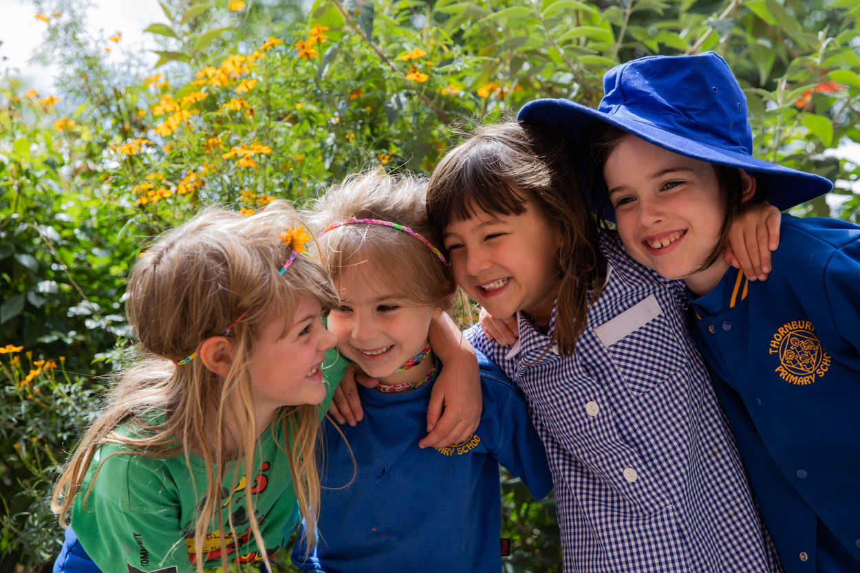 A group of children with arms around each other