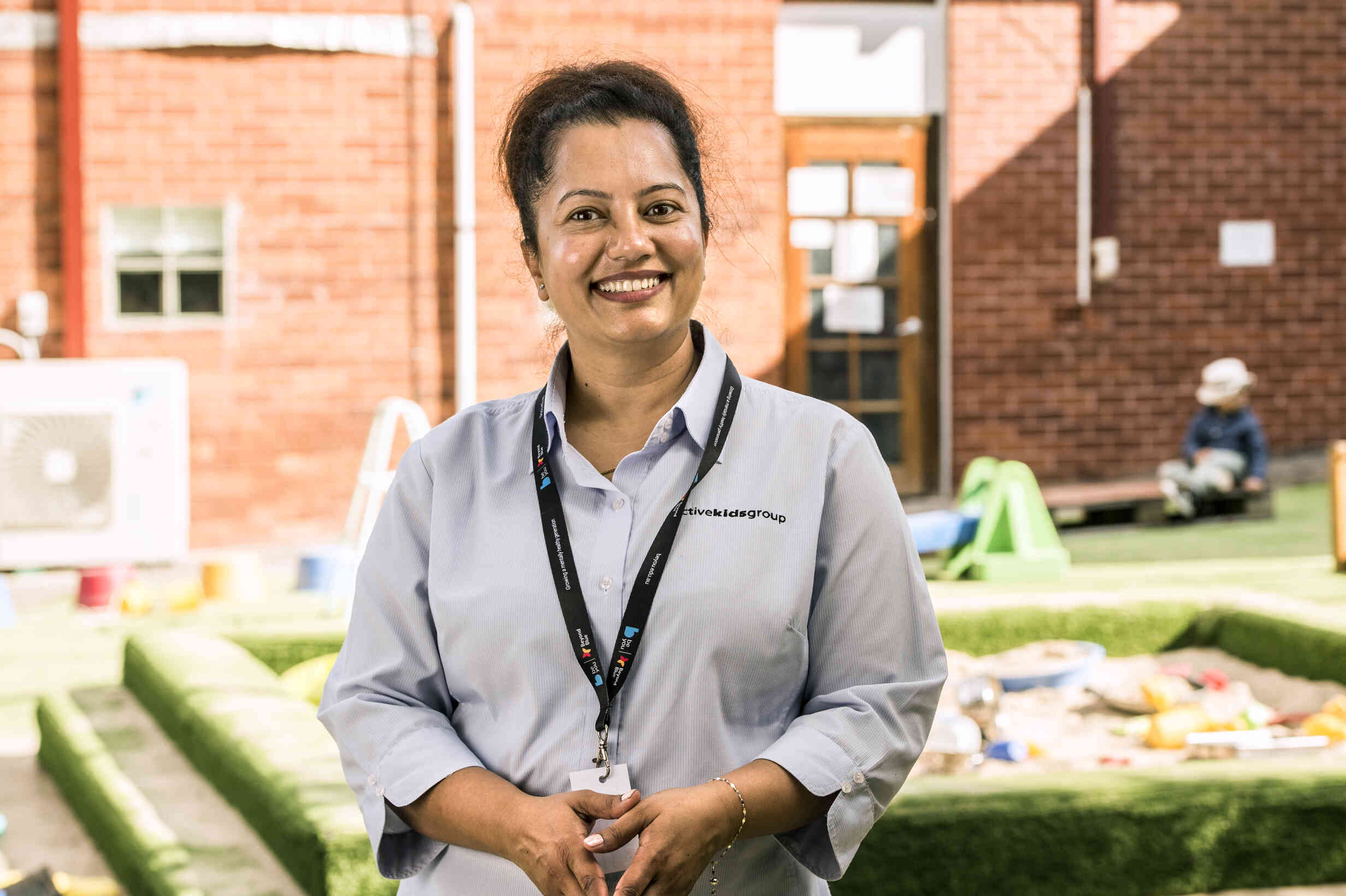 An educator, smiling at the camera