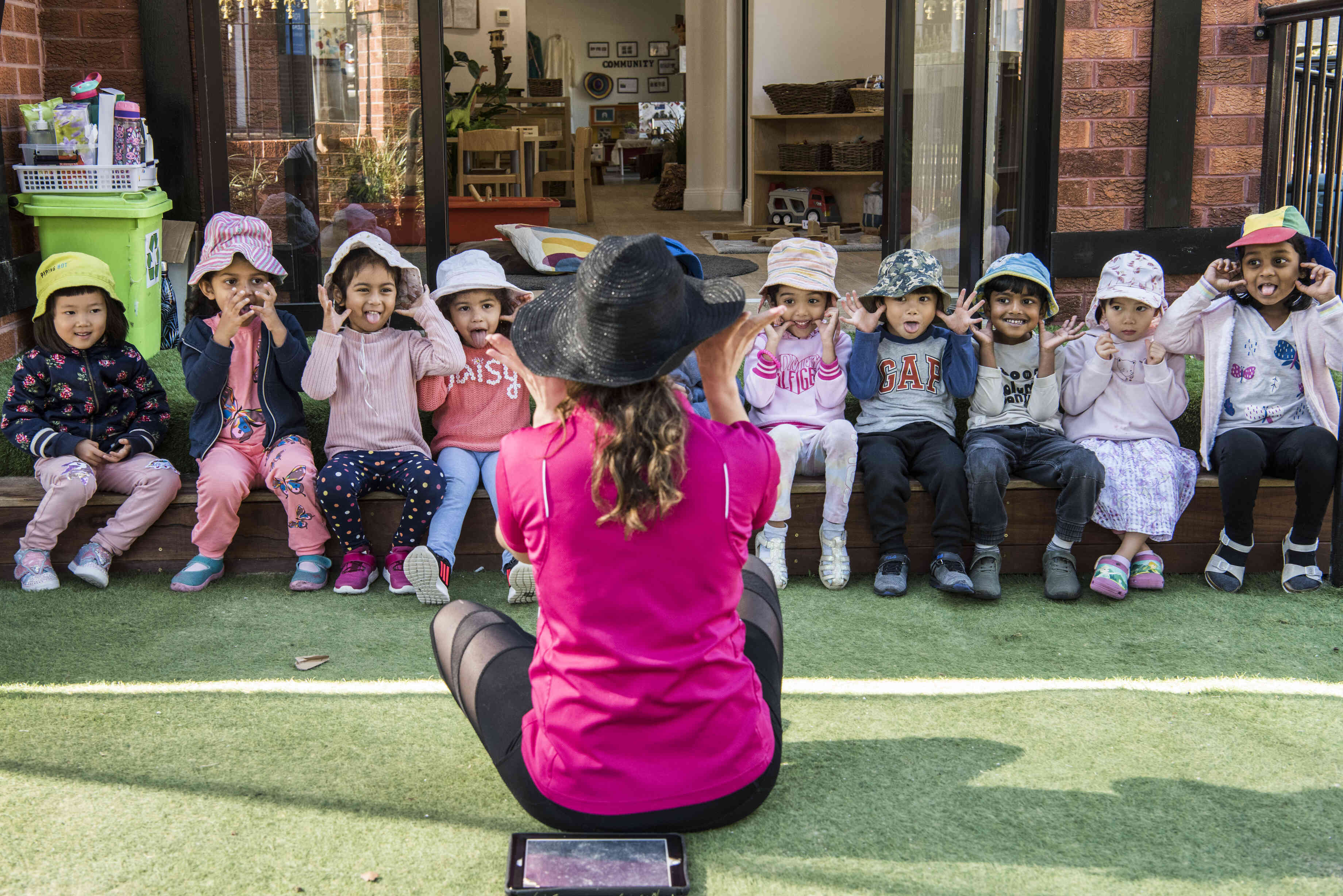 An educator sitting in front of a group of young children