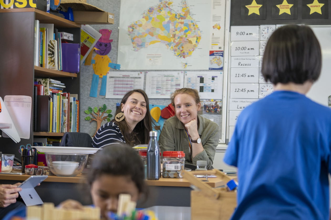 Two educators in a classroom with children