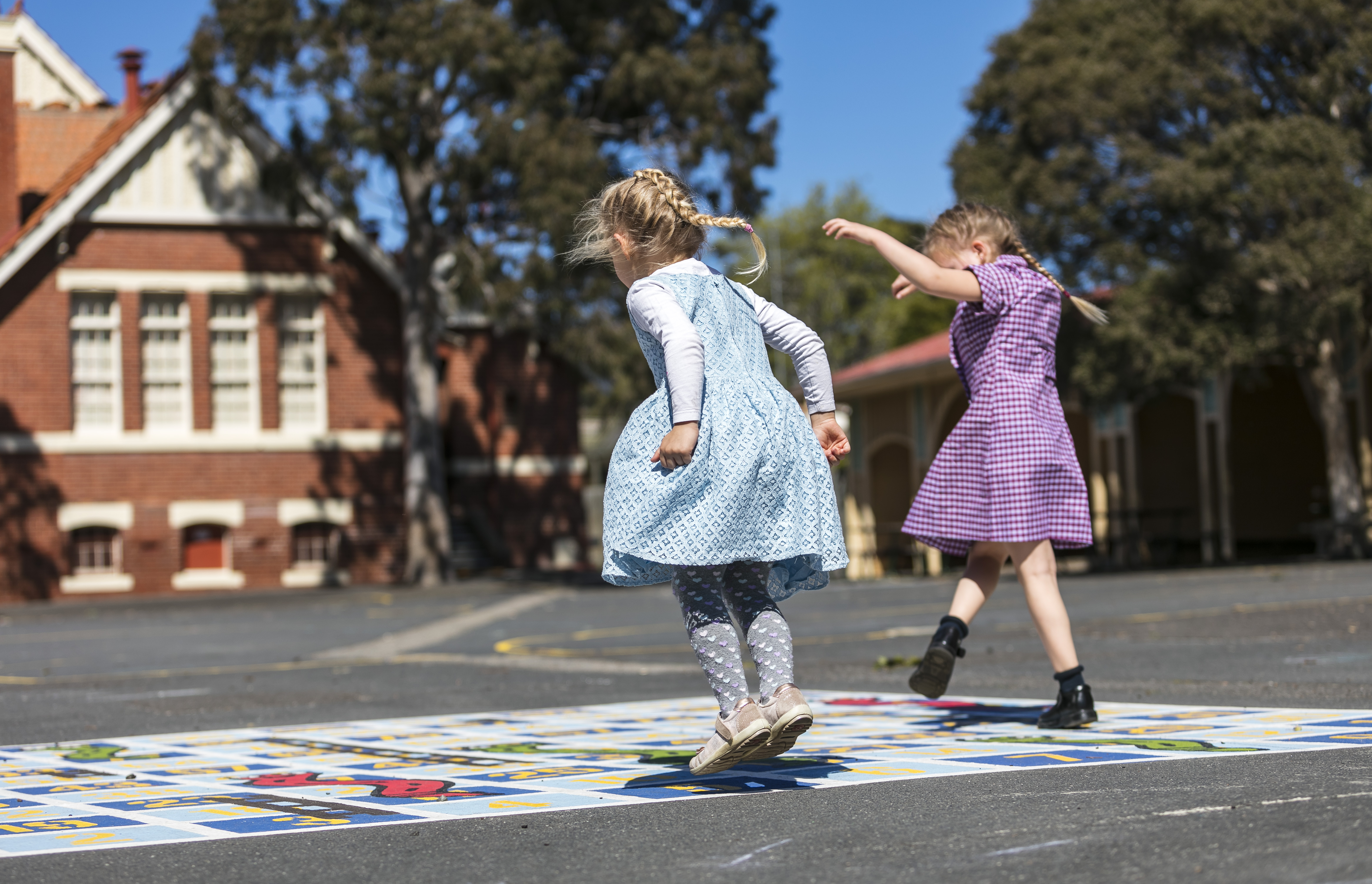 Two children playing games outside