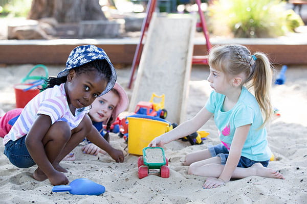 Young children playing in a sandpit