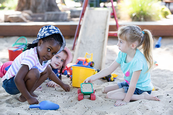 Young children playing in a sandpit