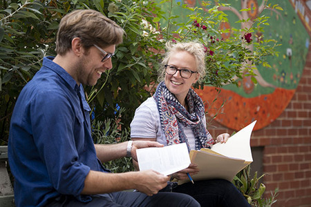 Two people reading together 