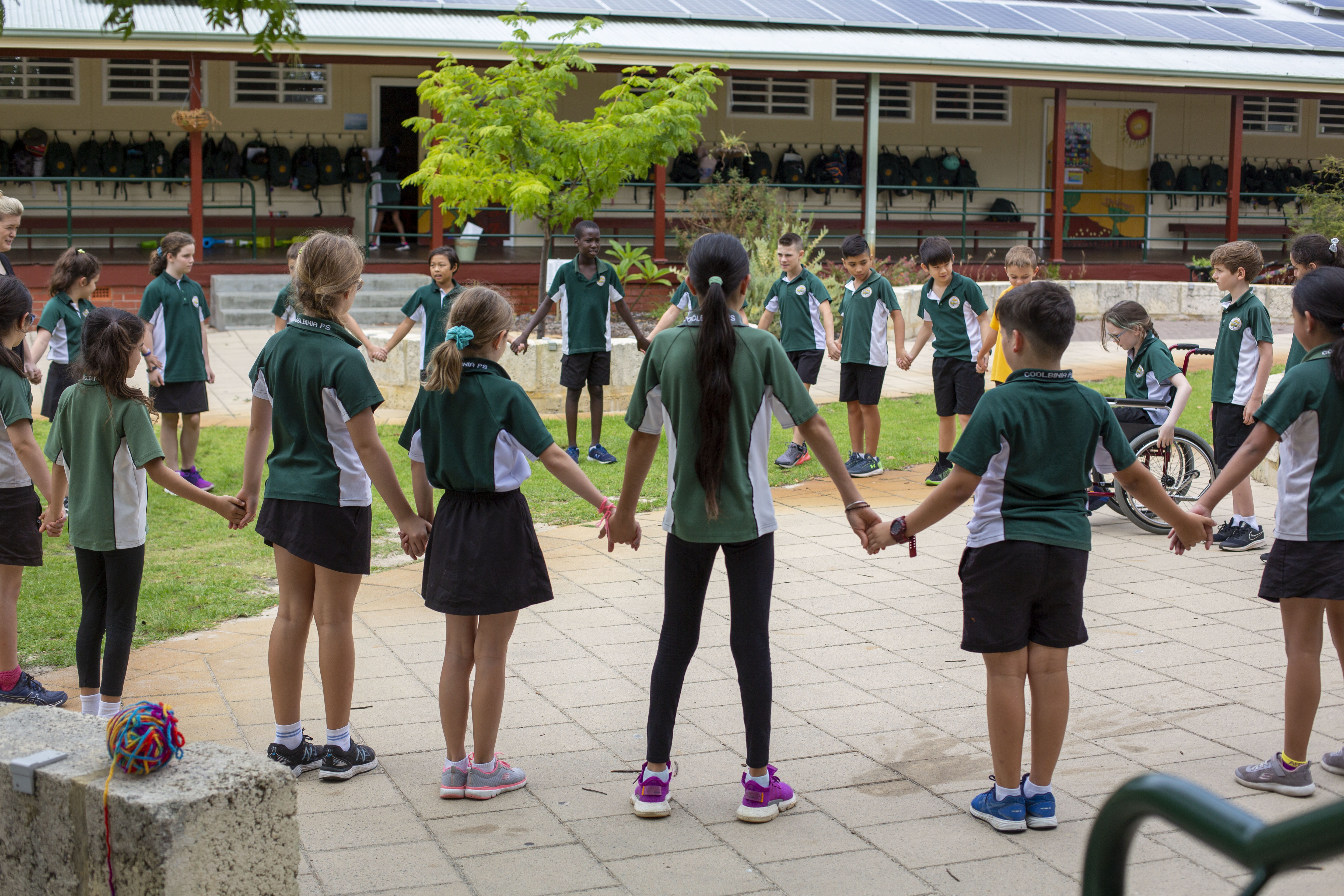 A group of children holding hands in a circle