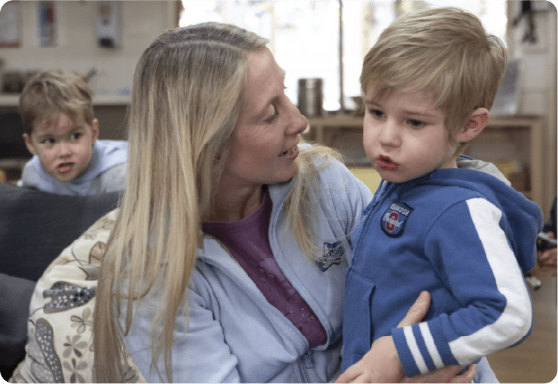 An adult with a young child at an early learning service