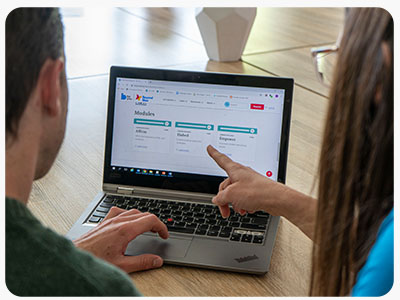 Educators working together on a laptop