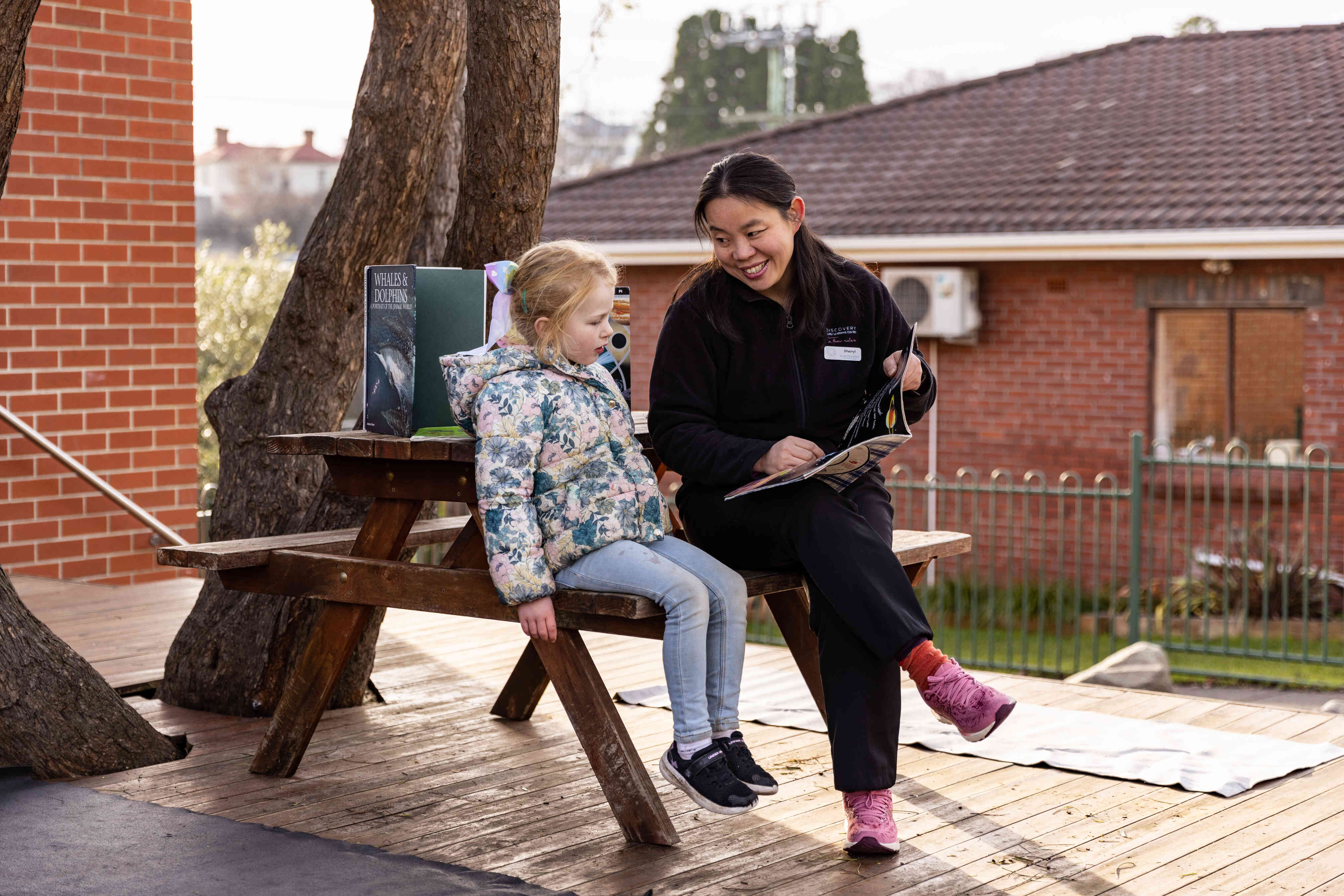 An educator reads to a child