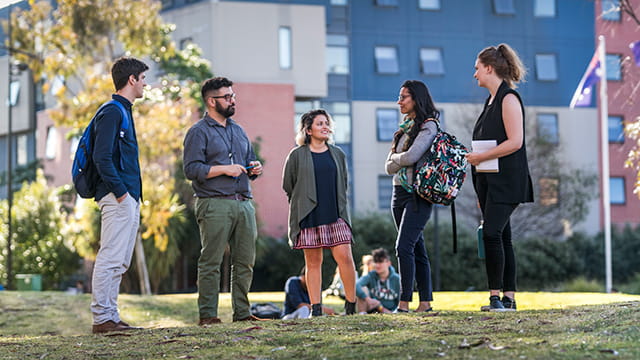 A group of educators standing on campus