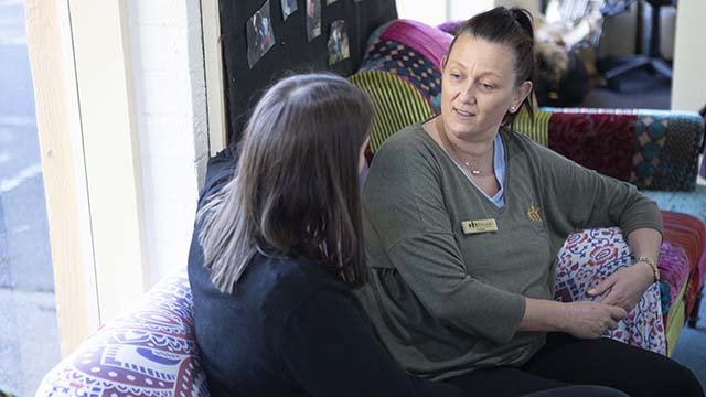 Two educators, engaged in conversation